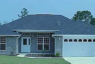 All-brick home with a hip roof and a two-car garage