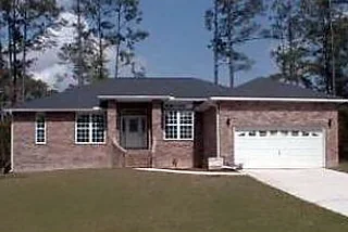 Brick ranch home with a front-entry garage and a new lawn
